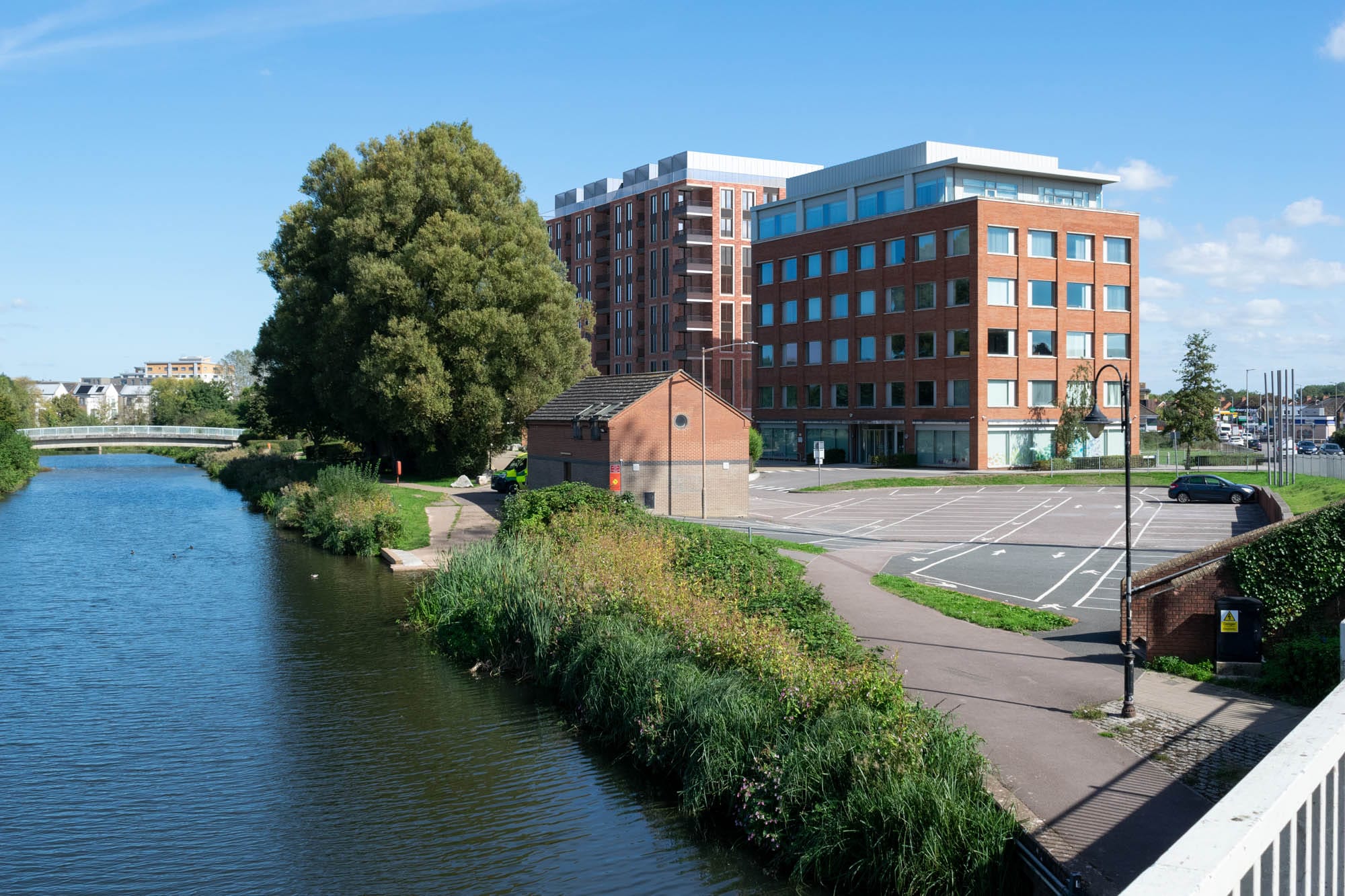 A rendered (AVR3) verified view of a proposed scheme in a town setting, on a bridge, next to a river. Alternative view (VP01)